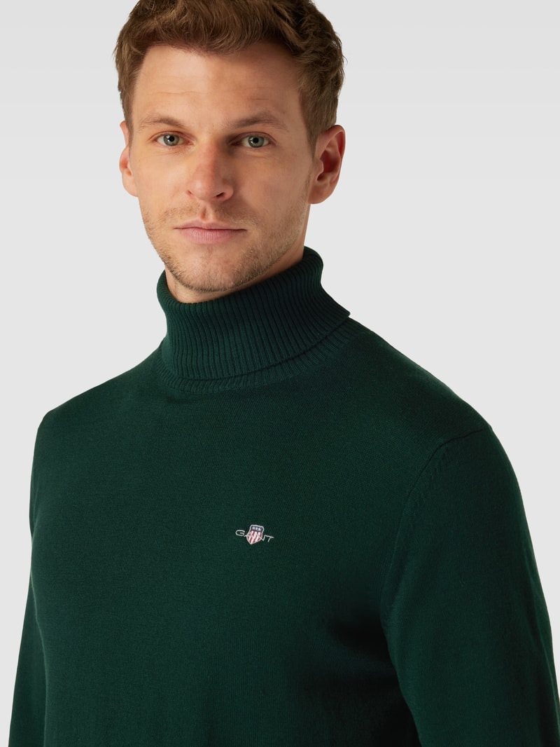 Rollkragenpullover mit Label-Stitching aus Baumwoll-Woll-Mix in dunkelgrün
