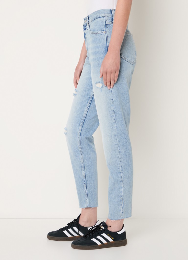 Calvin Klein high-waist mom jeans with a light wash and destroyed finish