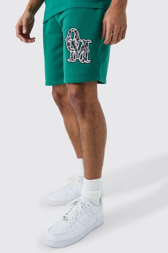 Lockere mittellange Shorts mit Applikation