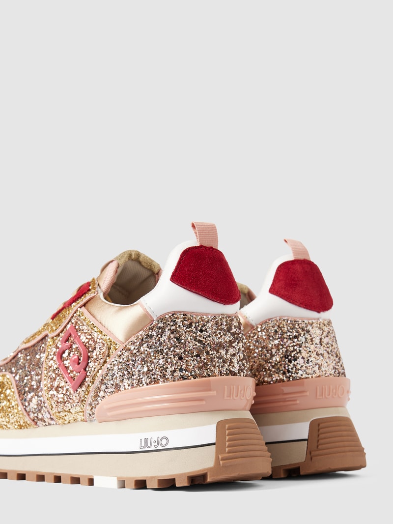 Sneaker mit Zierbesatz in gold