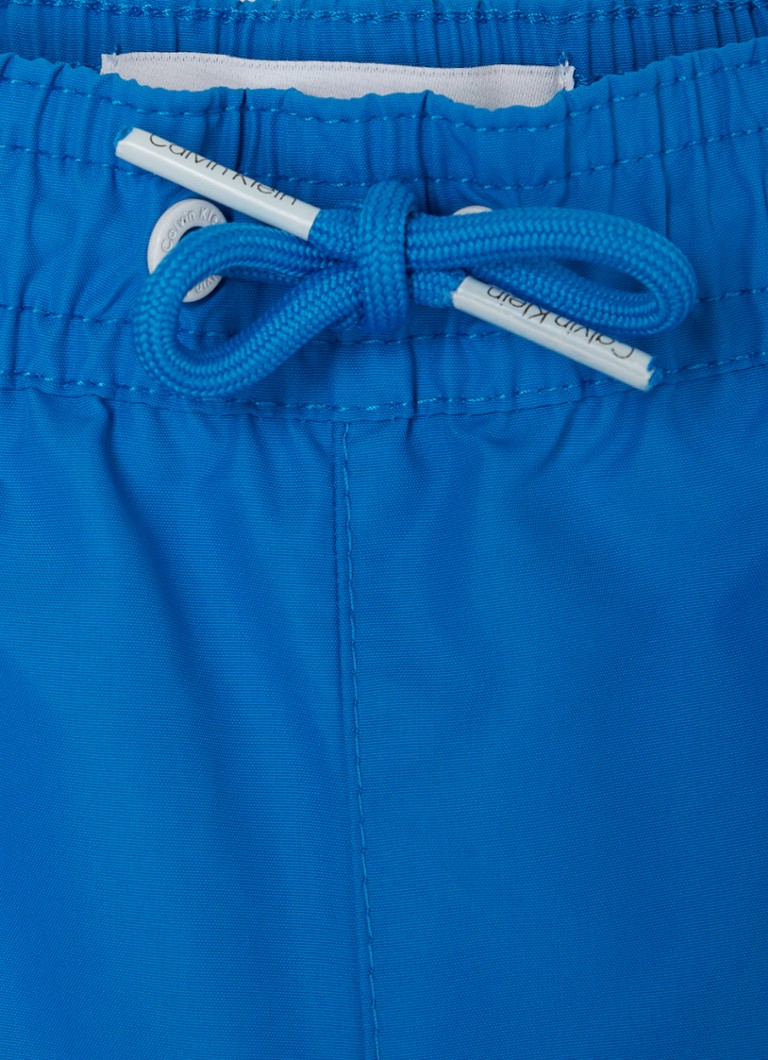 Calvin Klein swim shorts with side pockets and logo print