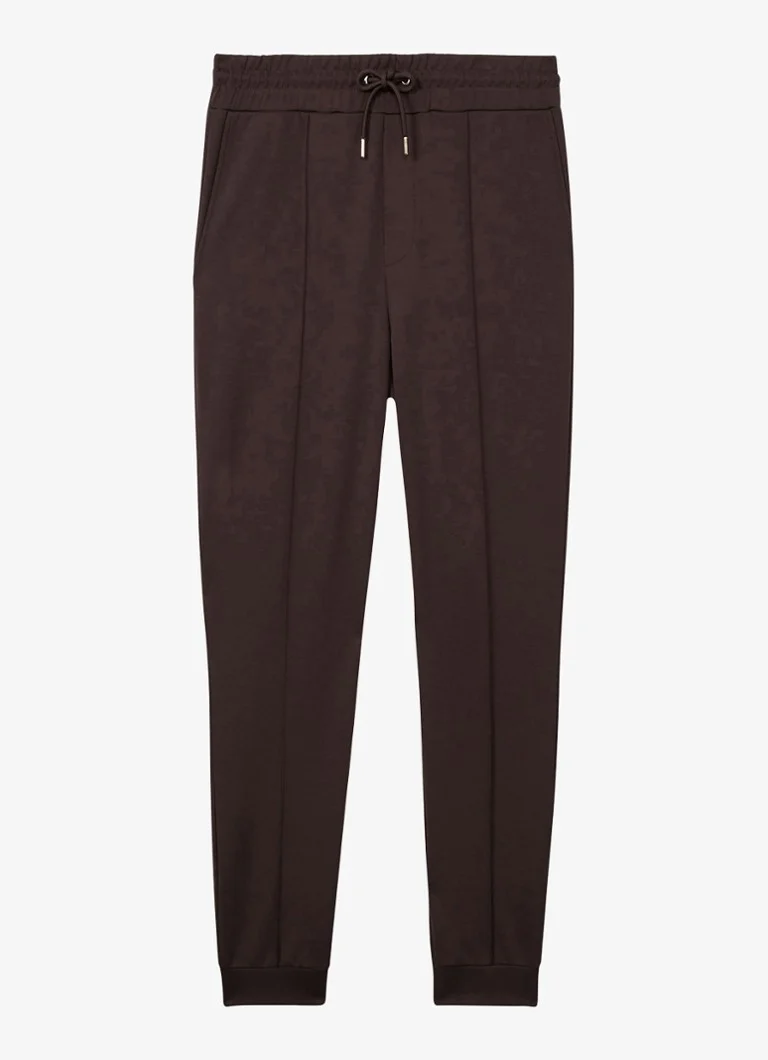 Pantaloni de trening conici Reiss Premier cu buzunare cusute.